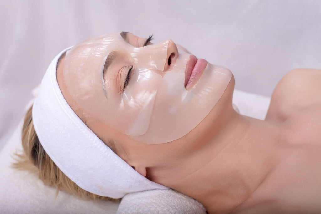 Woman applying collagen face mask