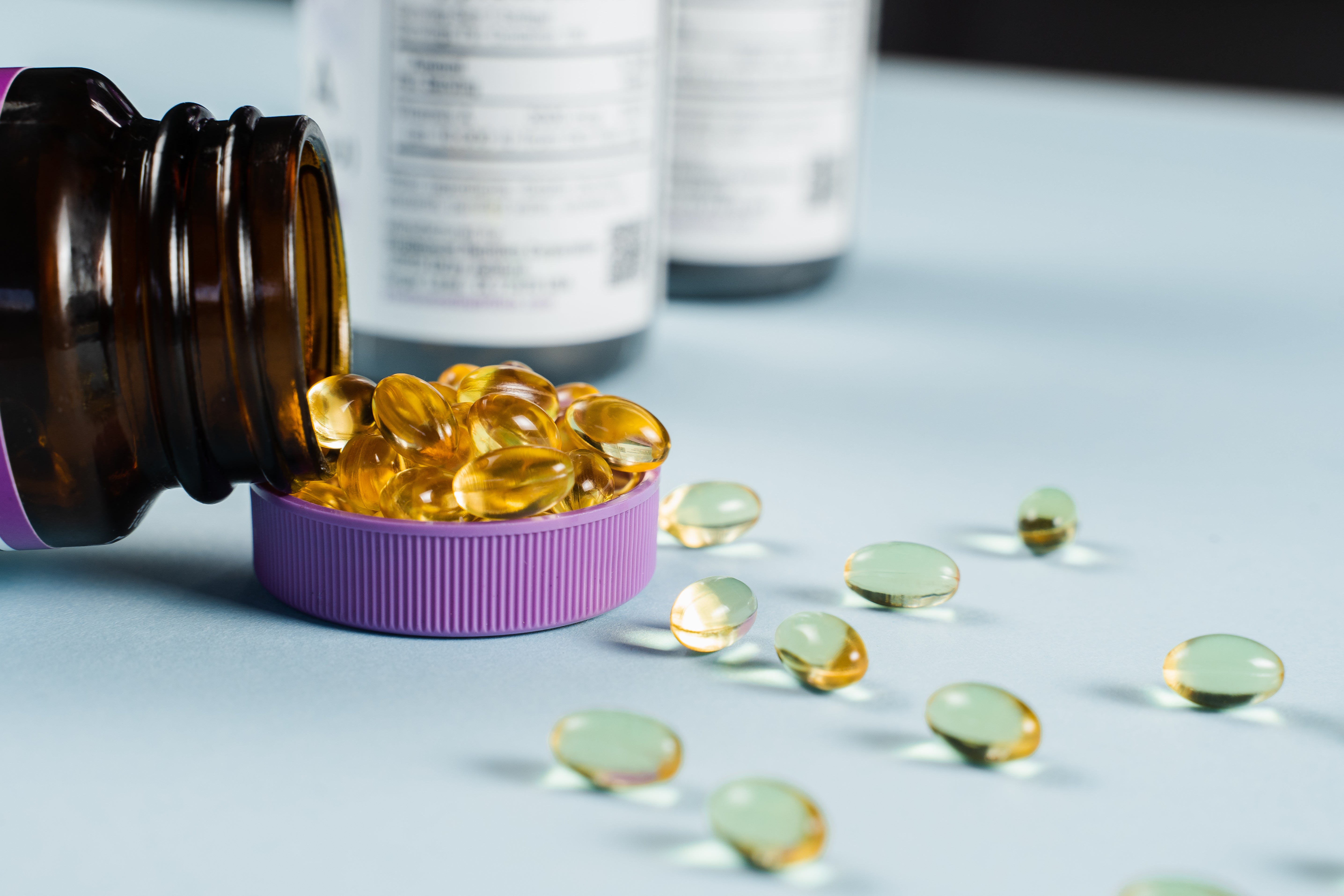 Hydrolyzed collagen supplement capsules spilling from bottle