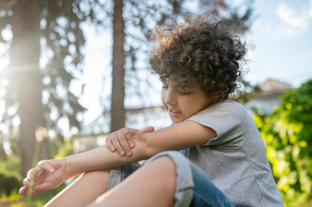 Kid examining his damaged elbow joint